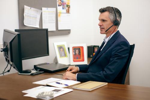 While this photo shows an office worker using a headset, the new version of Nuance's Dragon NaturallySpeaking supports built-in microphones on notebooks.