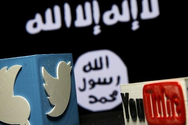A 3D plastic representation of the Twitter and Youtube logo is seen in front of a displayed ISIS flag in this photo illustration in Zenica, Bosnia and Herzegovina. Credit: REUTERS/Dado Ruvic